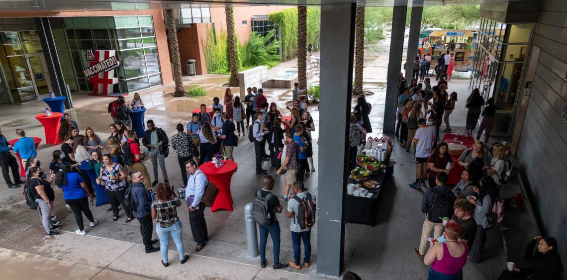 Group of students and faculty meeting in the Walkway of Wellness at Drachman Hall