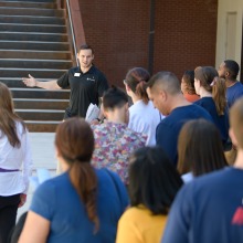 A student takes a group on a tour of the College of Pharmacy