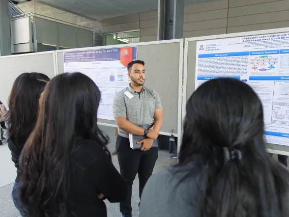 Student giving a poster presentation
