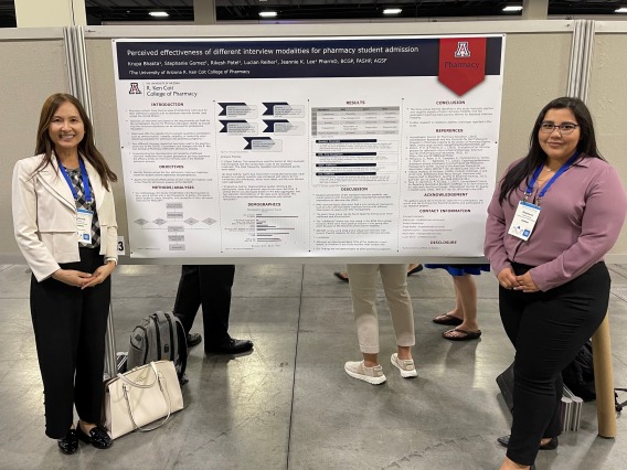 Dr. Jeannie Lee and Stephanie Gomez pose in front of their poster presentation