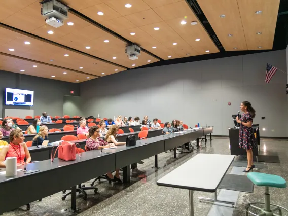 Faculty shares information about the College to parents during open house in a lecture hall. 