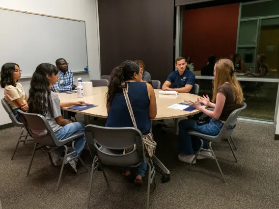 Prospective students speaking with current students during Open House