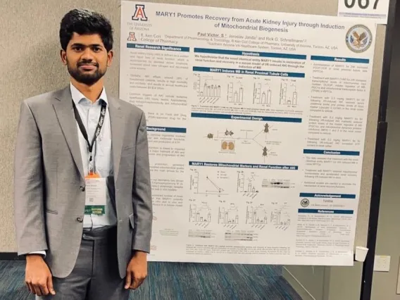 Paul Victor Santiago Raj stands before his poster at the 2024 American Society for Pharmacology and Experimental Therapeutics (ASPET) Annual Meeting 