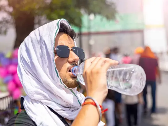 Man drinks water to stay cool