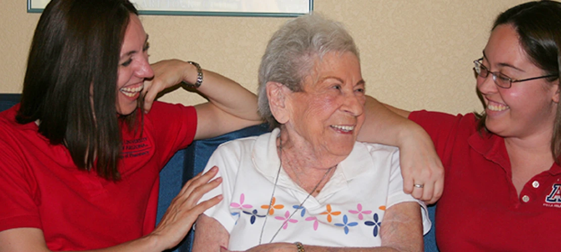 two pharmacy students interacting with a patient