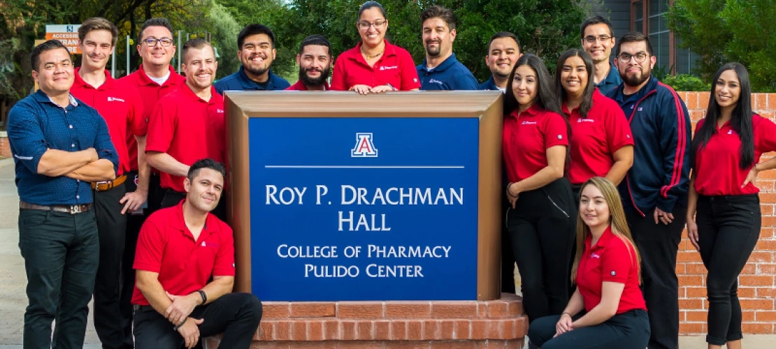 A group of Hispanic pharmacists around the Drachman hall board