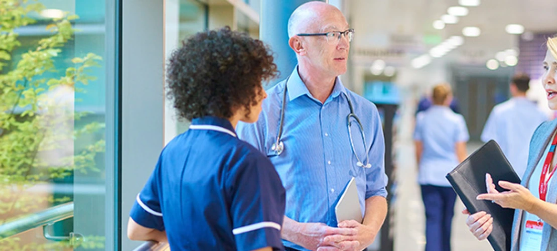 healthcare professionals talking to each other in the hallway