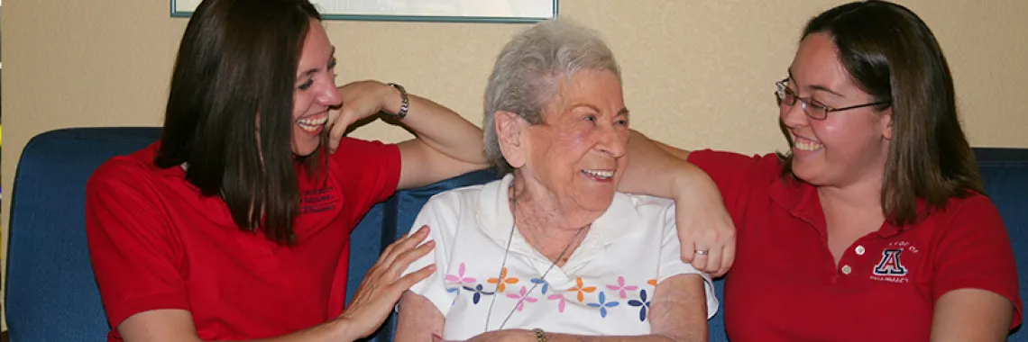 two pharmacy students interacting with a patient