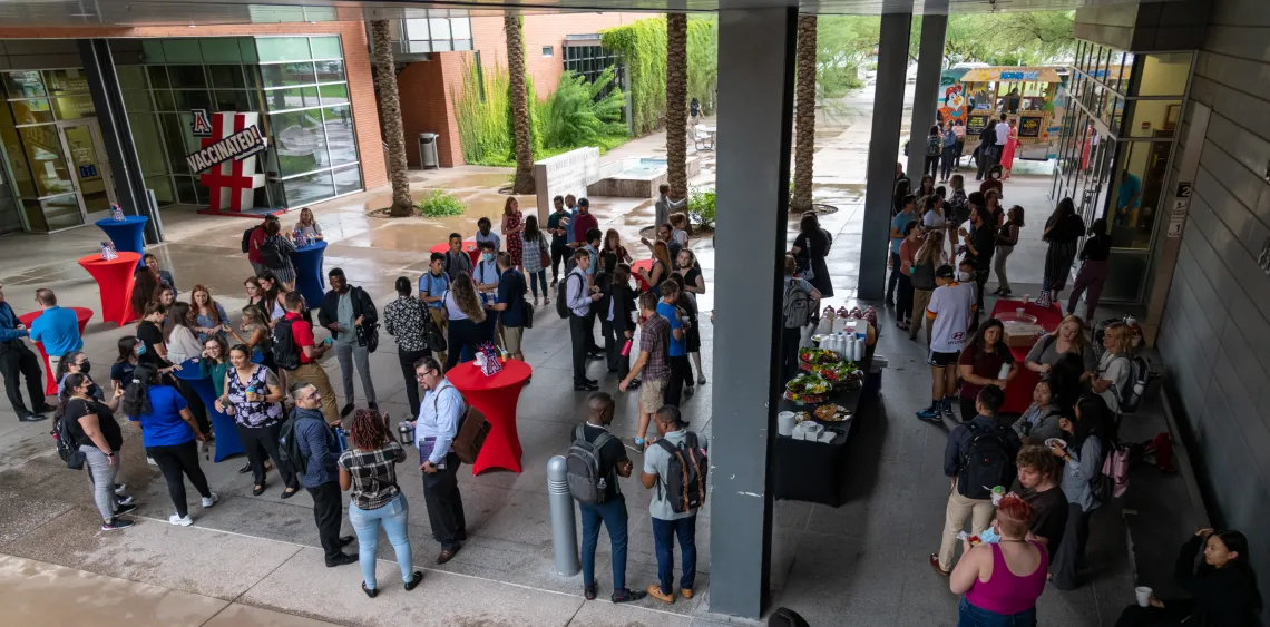 Group of students and faculty meeting in the Walkway of Wellness at Drachman Hall