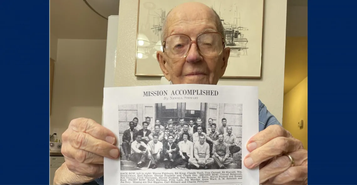 Gene Thompson holds up his Class of 1950 photo.