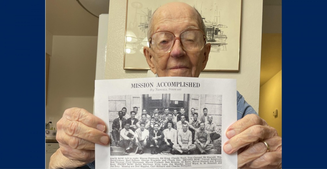 Gene Thompson holds up his Class of 1950 photo. 