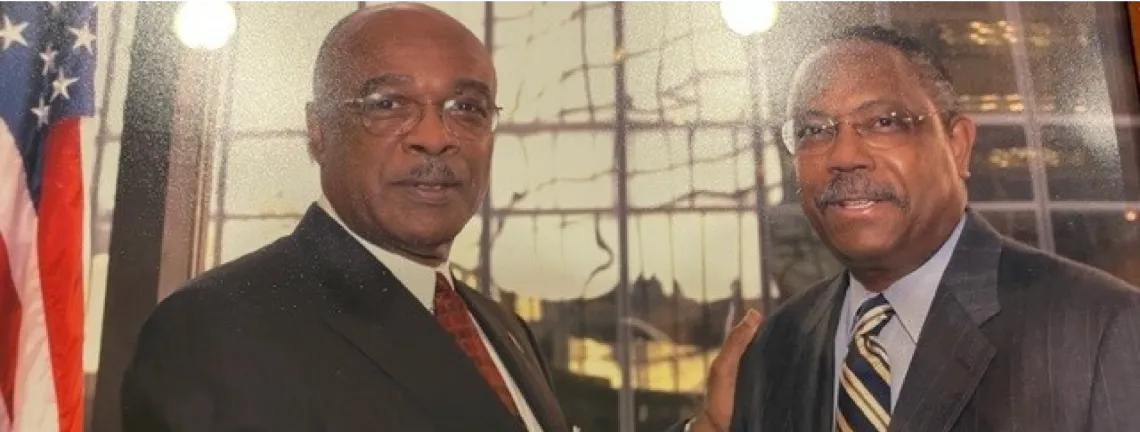 Dr. Pughsley shaking hands with the former U.S. Secretary of Education.