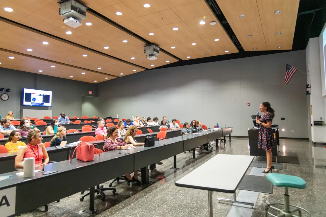 Faculty shares information about the College to parents during open house in a lecture hall. 