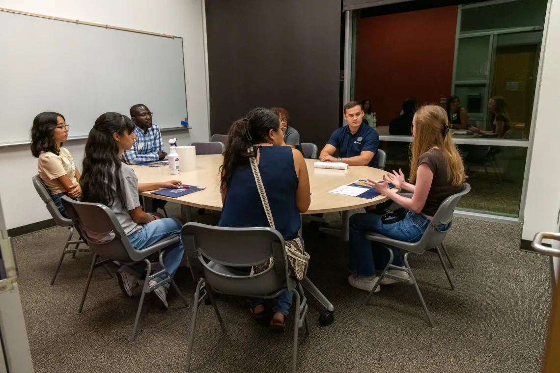 Prospective students speaking with current students during Open House