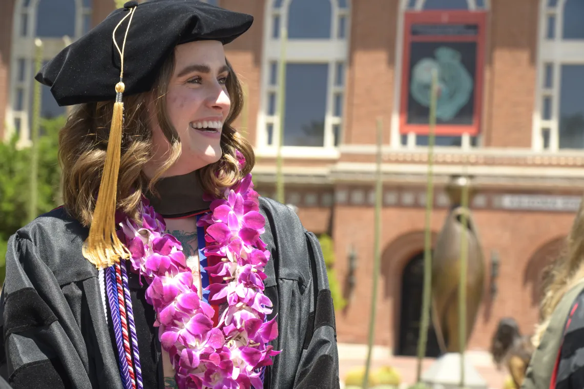 Photo of a female PharmD graduate.