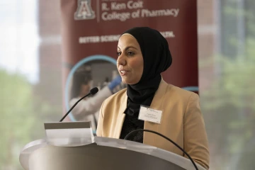 Woman at lectern gives speech