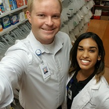 a selfie of two pharmacists at a pharmacy