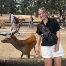 Woman stands with deer