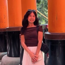 Woman in front of sculpture