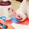 A pharmacist speaking with a patient during a health fair. 